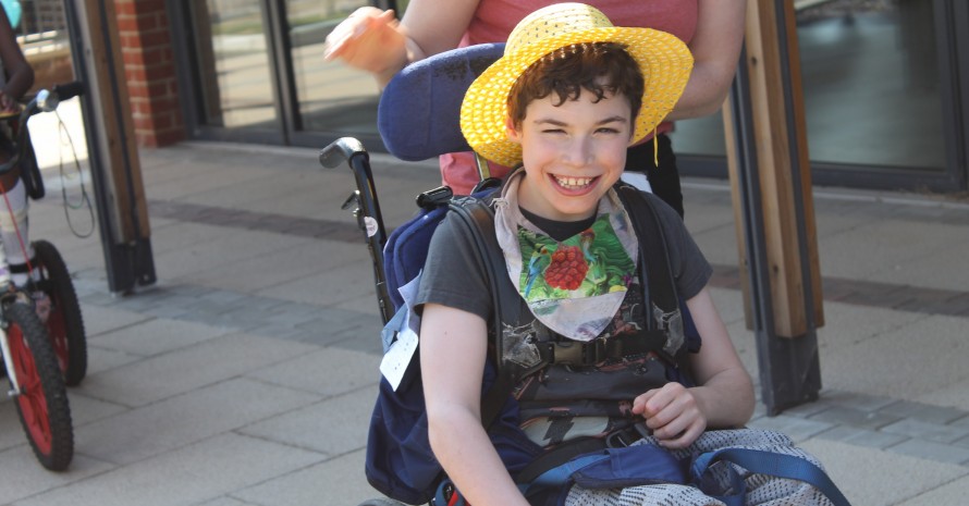 young boy in wheelchair smiling